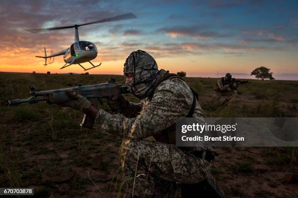Two-man security team deploys by helicopter at sunset for anti-poaching duties on the worlds largest Rhino breeding ranch. The teams are at work 24...