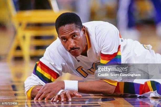 Alex English of the Denver Nuggets stretches against the Dallas Mavericks during a game played circa 1990 at McNichols Arena in Denver, Colorado....