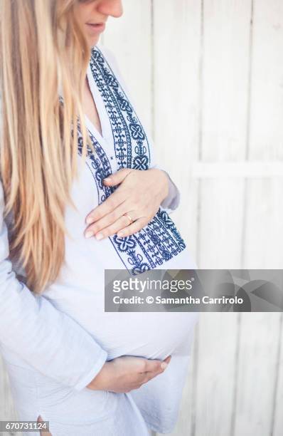 donna incinta. mani sul pancione. camicia a righe con ricamo. - connessione - fotografias e filmes do acervo