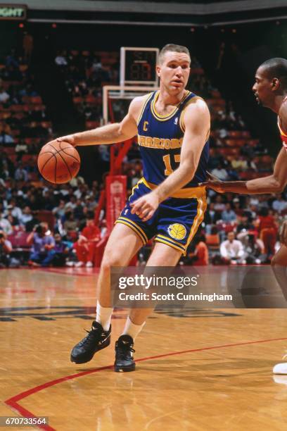 Chris Mullin of the Golden State Warriors dribbles against the Atlanta Hawks during a game played circa 1990 at the Omni in Atlanta, Georgia. NOTE TO...