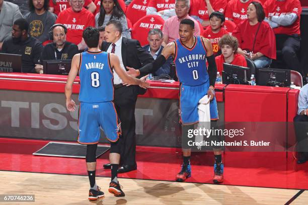 Alex Abrines and Russell Westbrook of the Oklahoma City Thunder high five during Game Two of the Western Conference Quarterfinals against the Houston...