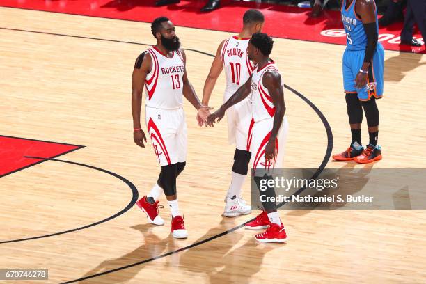 James Harden and Patrick Beverley of the Houston Rockets high five during Game Two of the Western Conference Quarterfinals against the Oklahoma City...