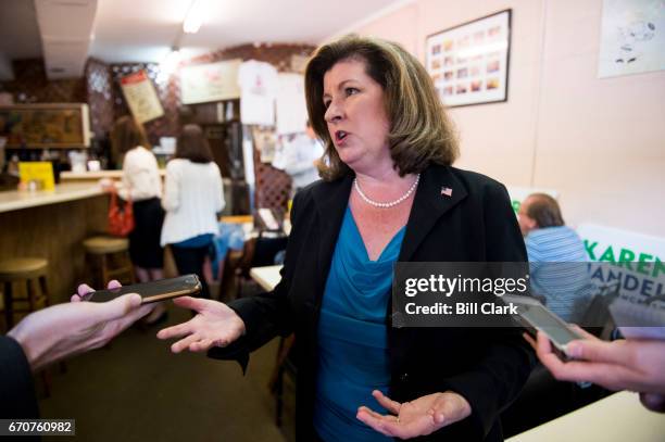 Karen Handel, candidate for the Georgia 6th Congressional district, speaks with reporters during a campaign stop at Rhea's restaurant in Roswell,...