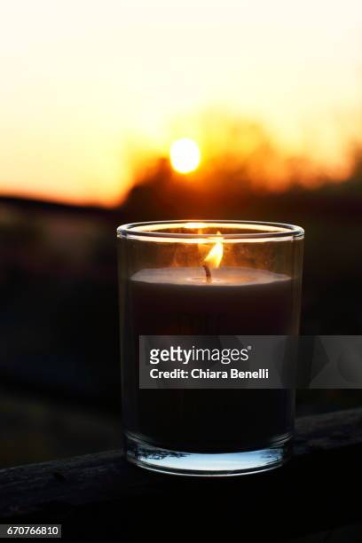 candle at sunset - crepuscolo stock-fotos und bilder