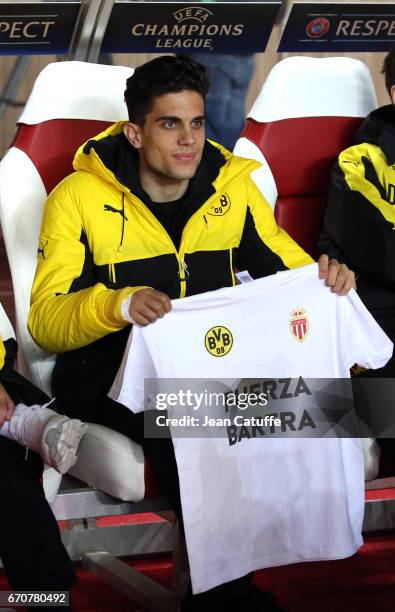 Marc Bartra of Dortmund, injured a week ago during the team's bus attack, looks on from the bench before the UEFA Champions League quarter final...