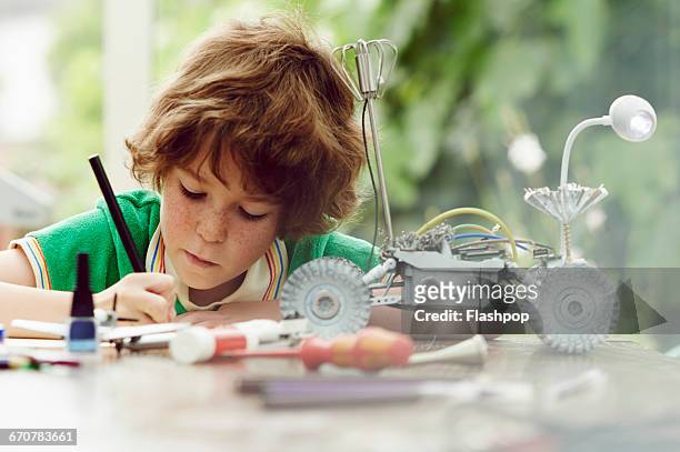 portrait of child being creative and making things - toples stockfoto's en -beelden
