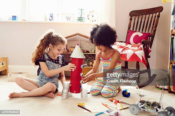 two children working together to make things - day 6 stock-fotos und bilder