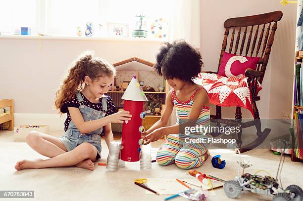 two children working together to make things - kids playing imagens e fotografias de stock