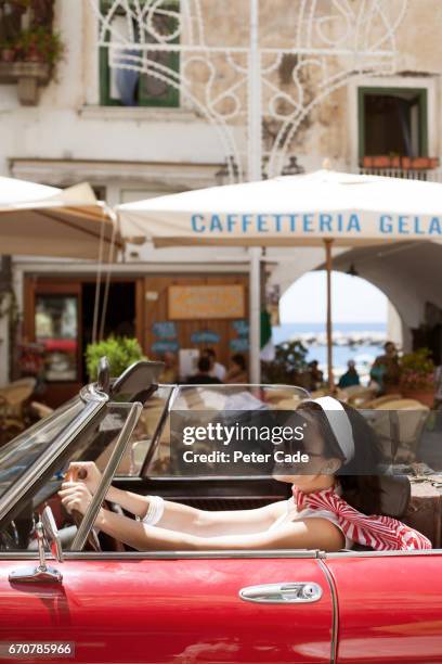 woman driving car with roof down in town - car top down stock pictures, royalty-free photos & images