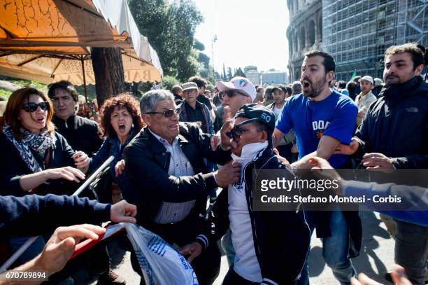 Protester's Jewish community , was stopped by protesters filo_palestinesi as he tries to wrest a Palestinian flag during the march for the Liberation...