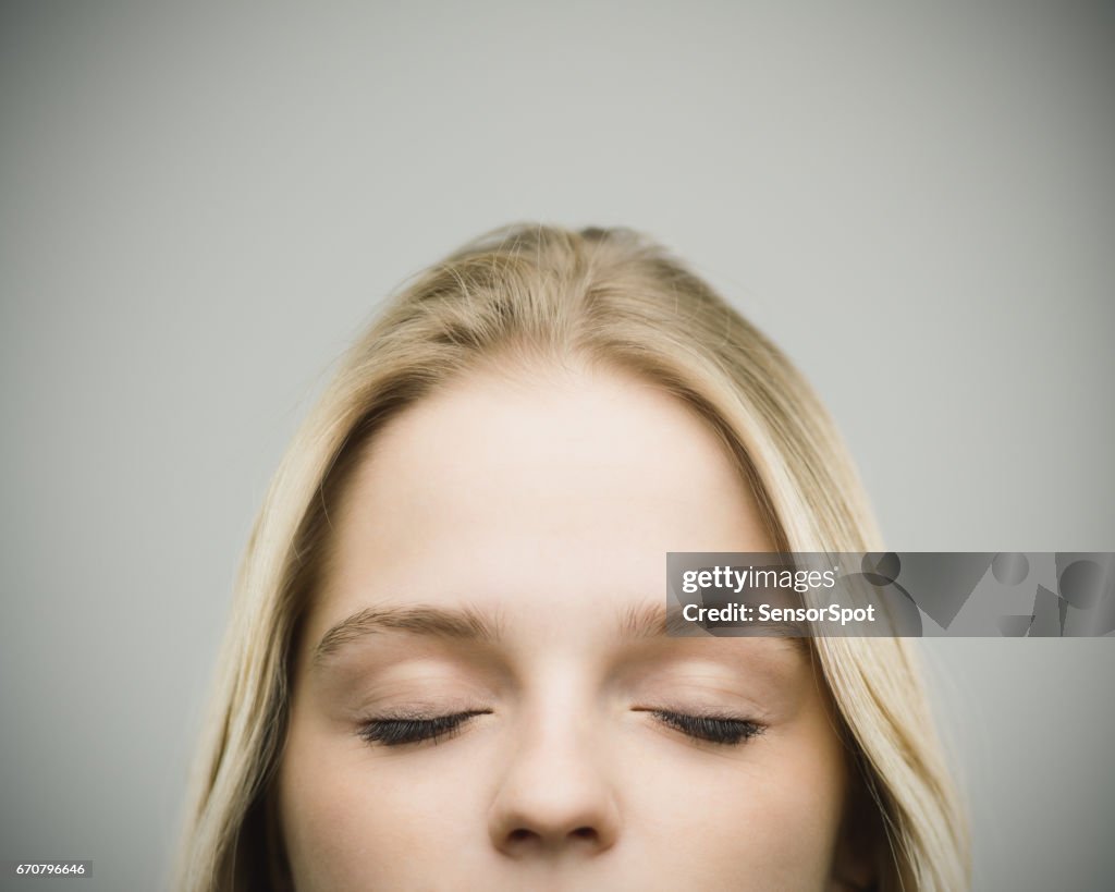 Relaxed woman smiling against gray background