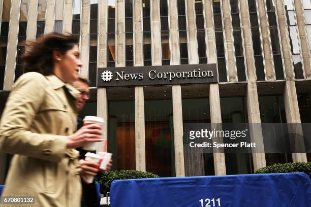 People walk by Fox headquarters a day after the popular television network fired host Bill O'Reilly on April 20, 2017 in New York City. O'Reilly was...