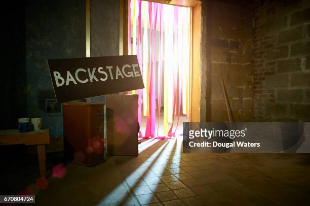 backstage sign with spotlight through theatre doorway. - backstage stockfoto's en -beelden