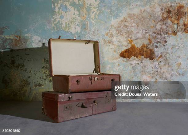 vintage suitcases in room with decaying wall. - vintage memorial day imagens e fotografias de stock