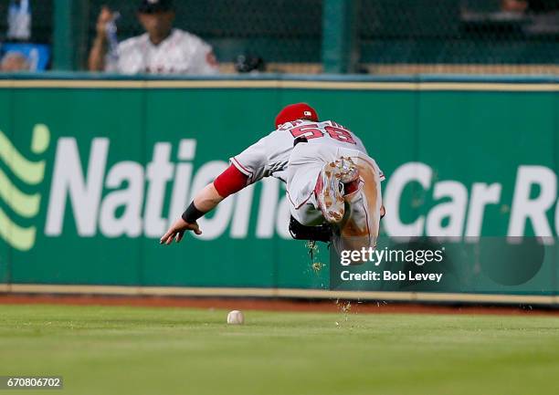 Kole Calhoun of the Los Angeles Angels of Anaheim has the ball deflect off his glove on a line drive by Alex Bregman of the Houston Astros in the...