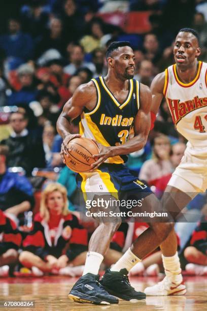 Dale Davis of the Indiana Pacers passes the ball against the Atlanta Hawks during a game played circa 1990 at the Omni in Atlanta, Georgia. NOTE TO...