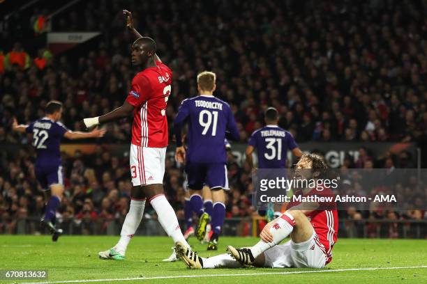 Daley Blind of Manchester United and Eric Bailly react after Sofiane Hanni of Anderlecht scored his team's first goal to make the score 1-1 during...