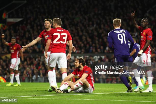 Daley Blind of Manchester United and his team-mates react after Sofiane Hanni of Anderlecht scored his team's first goal to make the score 1-1 during...