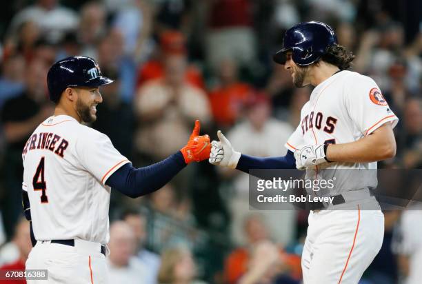 Jake Marisnick of the Houston Astros is congraturlated by George Springer of the Houston Astros after hitting a home run in the fifth inning against...