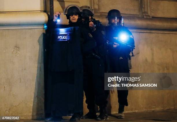 Police officers block the access of a street near the Champs Elysees in Paris after a shooting on April 20, 2017. One police officer was killed and...