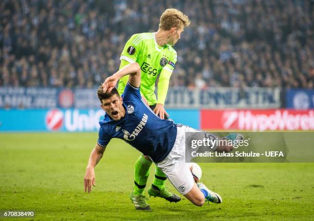 Klaas-Jan Huntelaar of Schalke is challenged by Matthijs de Ligt of Amsterdam during the UEFA Europa League quarter final second leg match between FC...