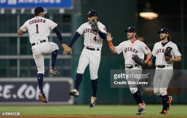 Carlos Correa of the Houston Astros celebrates with George Springer along with Josh Reddick and Jake Marisnick after the final out against the Los...