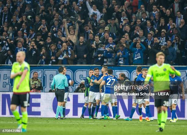 Daniel Caliguri of Schalke and his team mates celebrate their third goal during the UEFA Europa League quarter final second leg match between FC...