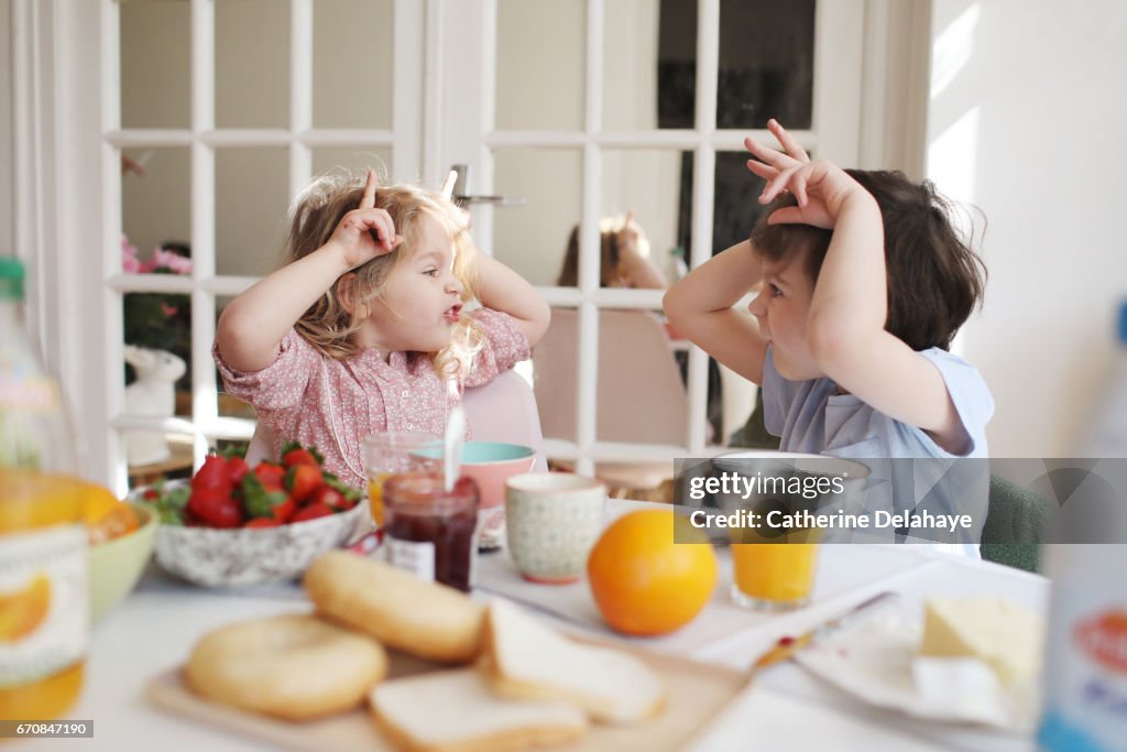 A brother and a sister having their breakfast