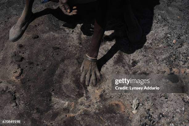 Sudanese civilians pick through the remains of their burned-out huts, and start to rebuild in the village of Abu Sourouj, which was bombed on...