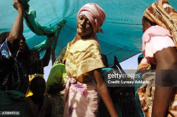 Family and friends of a bride and groom partake in the wedding celebration under a tent at Hamsa Dakika, a camp for Internally Displaced People, in...