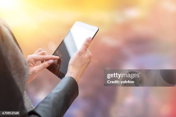 woman & digital tablet on colored background - ipad touching stock pictures, royalty-free photos & images