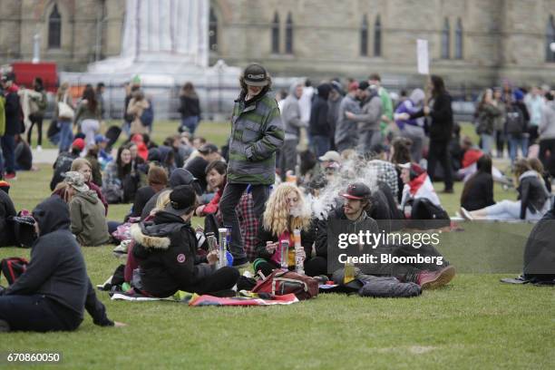 Resident smokes marijuana from a bong during the 420 Day festival on the lawns of Parliament Hill in Ottawa, Ontario, Canada, on Thursday, April 20,...