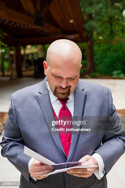 groom at wedding doing a reading - reading wedding vows stock pictures, royalty-free photos & images