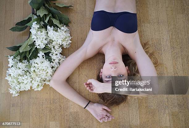 girl lying on floor with flowers - young teen bathing suit stock pictures, royalty-free photos & images