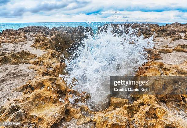 florida, jupiter, wave splashing on rock formation - jupiter florida stock pictures, royalty-free photos & images