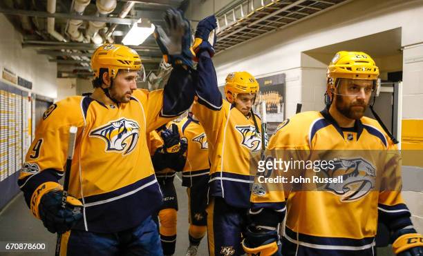 Filip Forsberg and Calle Jarnkrok of the Nashville Predators tap gloves as they walk out for Game Four of the Western Conference First Round against...