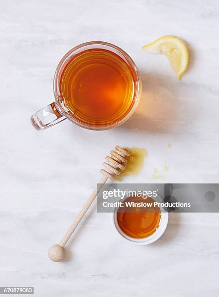 overhead view of cup of tea and bowl of honey on marble table - tea cup overhead view photos et images de collection