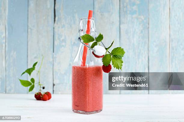 raspberry smoothie in swing top bottle - raspberry smoothie stock pictures, royalty-free photos & images