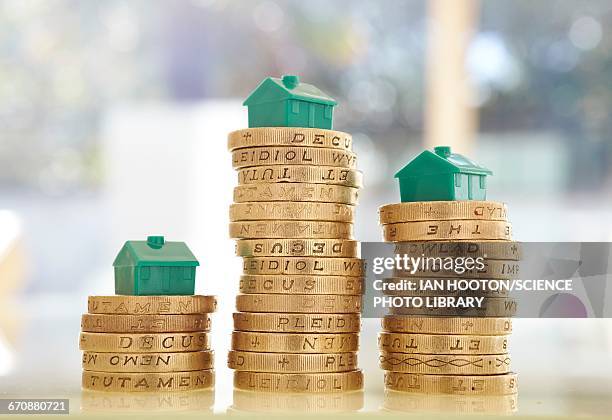 british pound coins with model houses - british library stock pictures, royalty-free photos & images