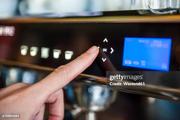 finger pushing digital button on coffee machine - kaffeemaschine stock-fotos und bilder