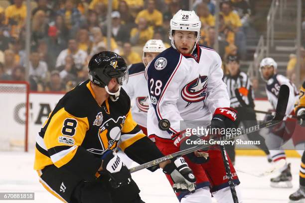 Oliver Bjorkstrand of the Columbus Blue Jackets blocks the puck off the stick of Brian Dumoulin of the Pittsburgh Penguins during the first period in...