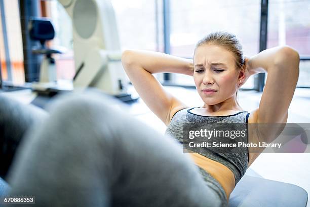 young woman exercising - sports pain stock-fotos und bilder