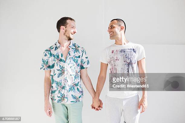 two men in love holding hands - gay couple in love 個照片及圖片檔