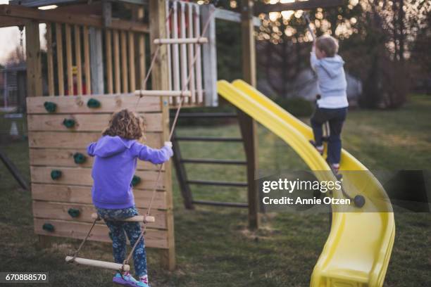 kids playing outdoors - rutsche stock-fotos und bilder