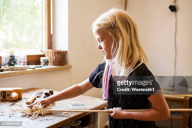 girl in workshop working on stone-age spear-thrower - carving craft activity bildbanksfoton och bilder
