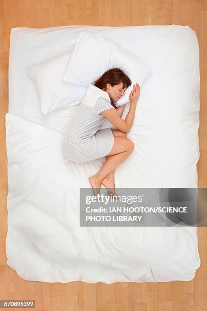 woman lying in bed, asleep - acostado de lado fotografías e imágenes de stock