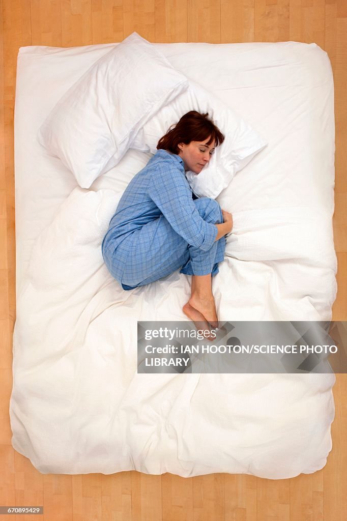 Woman lying in bed, asleep