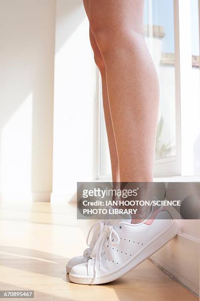 young woman wearing white trainers - white women feet fotografías e imágenes de stock