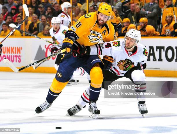 James Neal of the Nashville Predators and Niklas Hjalmarsson of the Chicago Blackhawks fight for a puck during the first period in Game Four of the...