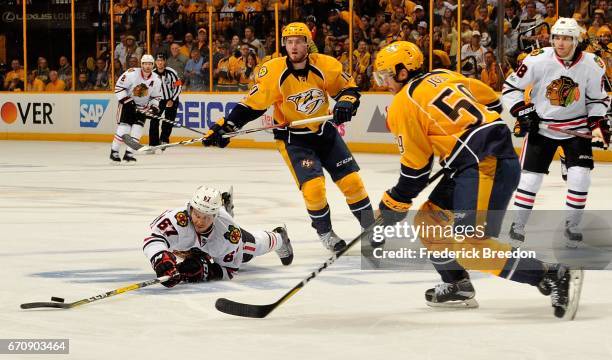 Tanner Kero of the Chicago Blackhawks falls in front of Roman Josi of the Nashville Predators during the second period in Game Four of the Western...
